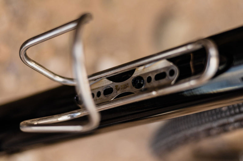 Load image into Gallery viewer, Titanium Wolf Tooth Morse Bottle Cage - Silver, Adjustable Vertical Placement, Hand-Bent Hollow Tubing, Bolt-On Compatibility for Standard Bike Frames, Lightweight and Durable Cycling Accessory