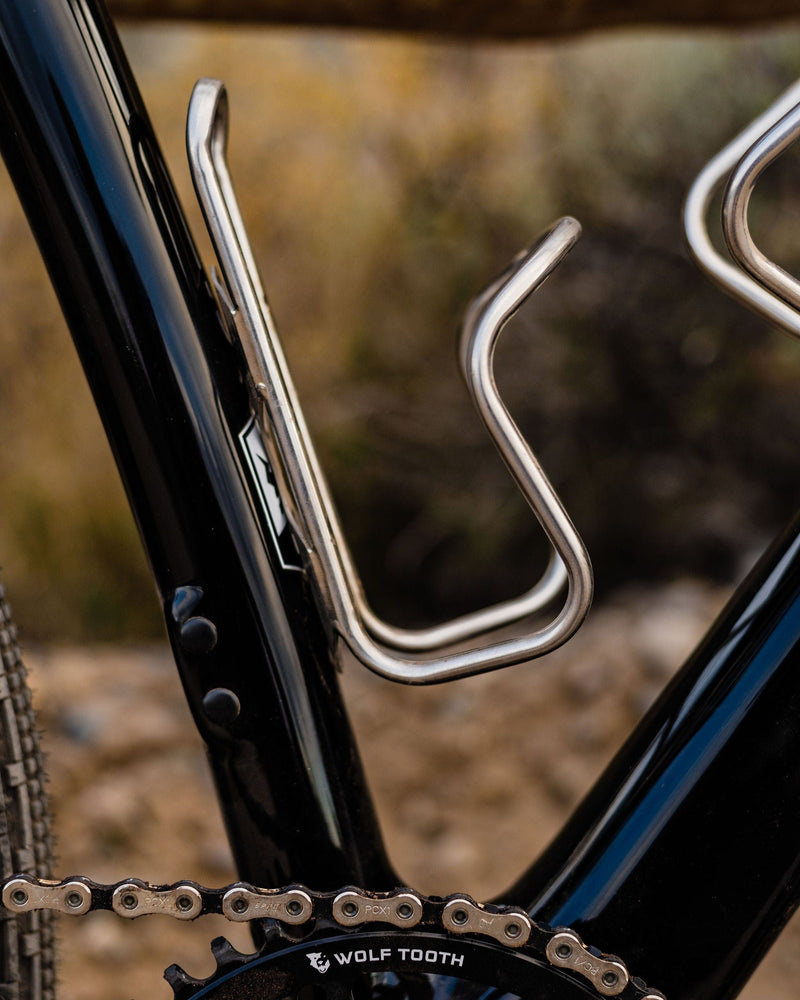 Load image into Gallery viewer, Wolf Tooth Morse Titanium Bottle Cage - Adjustable, Lightweight Titanium Bike Bottle Holder with Repositionable Base Plate for Mountain & Road Cycling