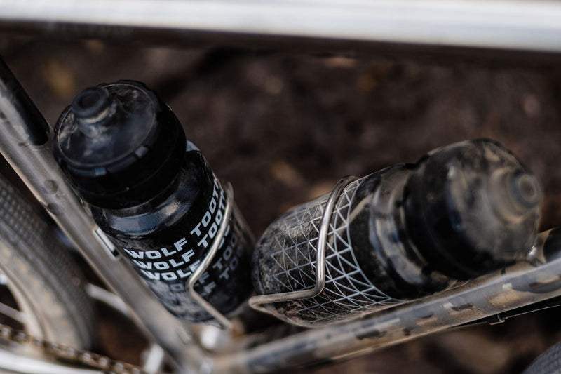 Load image into Gallery viewer, Titanium Wolf Tooth Morse Bottle Cage - Silver, Adjustable Vertical Placement, Hand-Bent Hollow Tubing, Bolt-On Compatibility for Standard Bike Frames, Lightweight and Durable Cycling Accessory